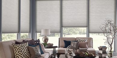 Bedroom with roller shades and window blinds