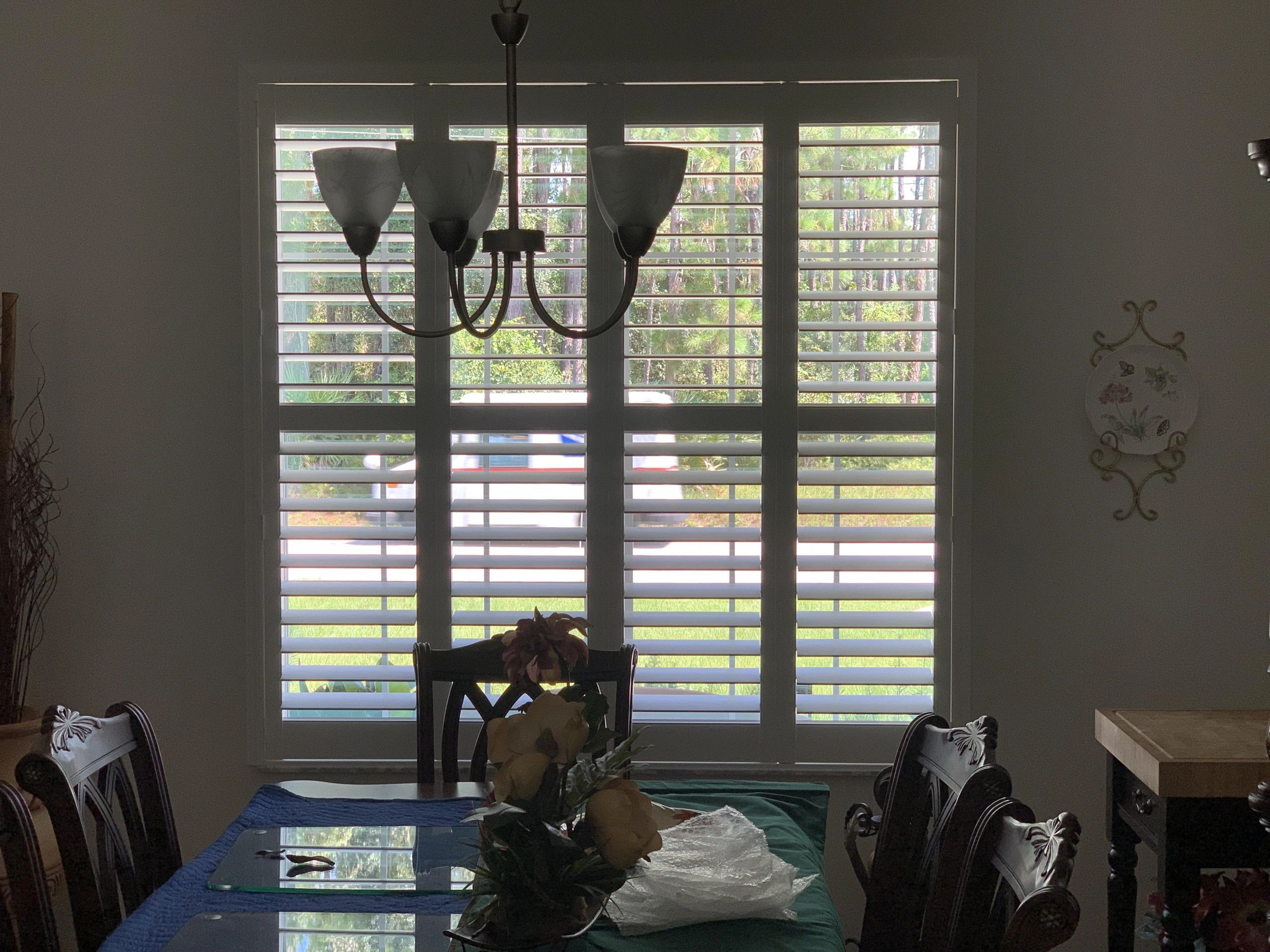 Bright living room with shuttered doors and natural light