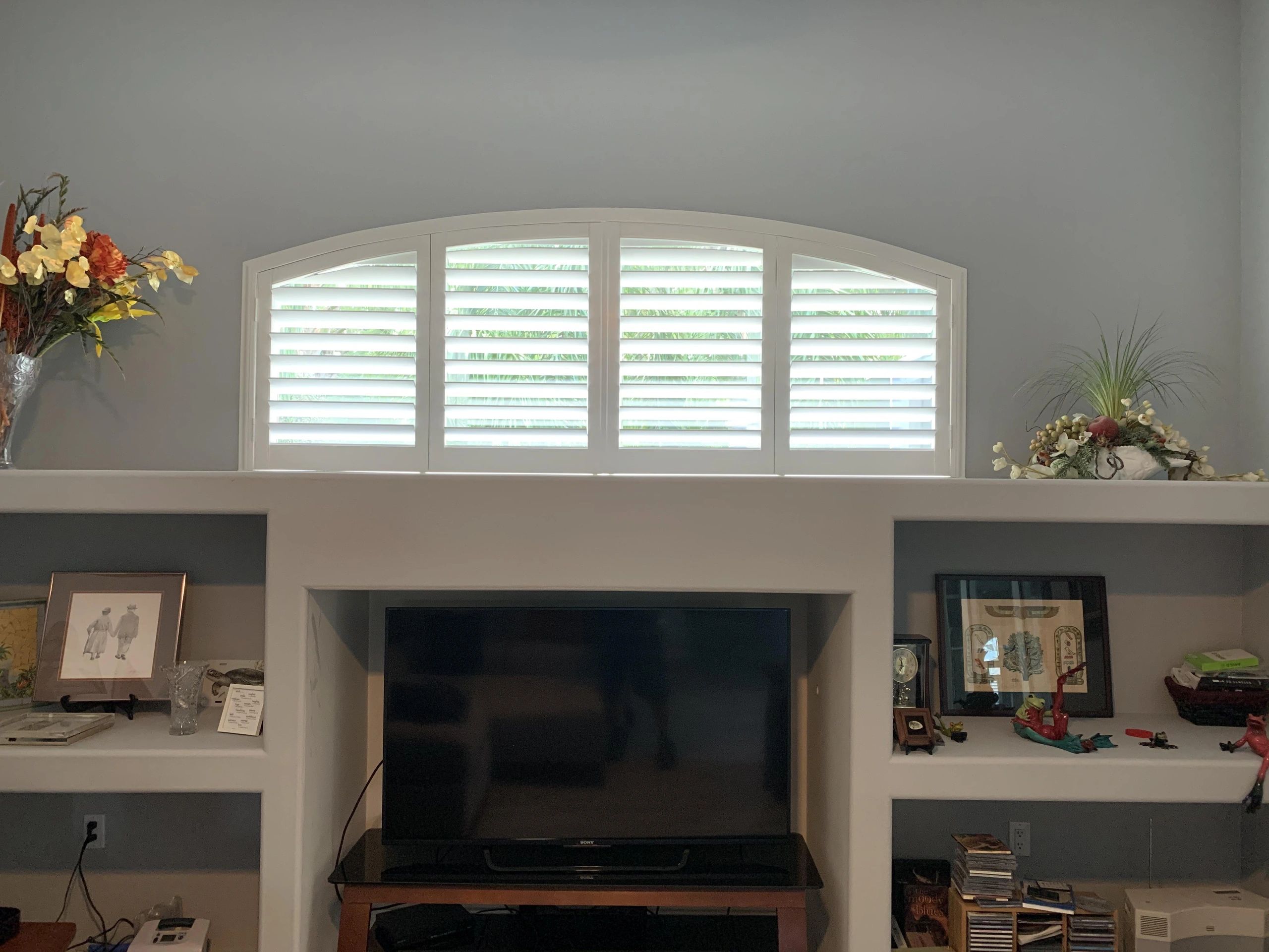 Luxury bathroom with arched window and plantation shutters