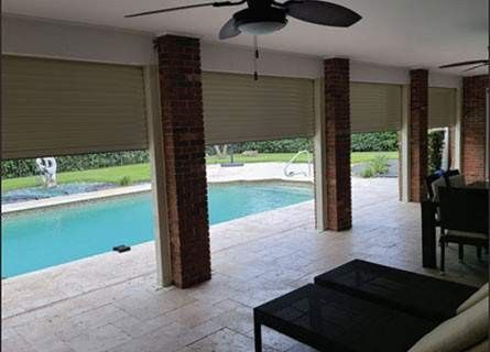 Patio roller shades and poolside outdoor living area